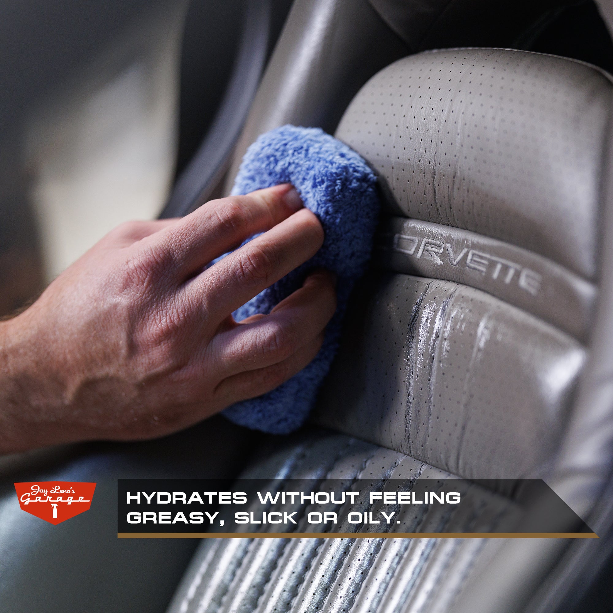 Hand cleaning a Corvette car seat with a microfiber applicator, with a focus on hydrating without feeling greasy.